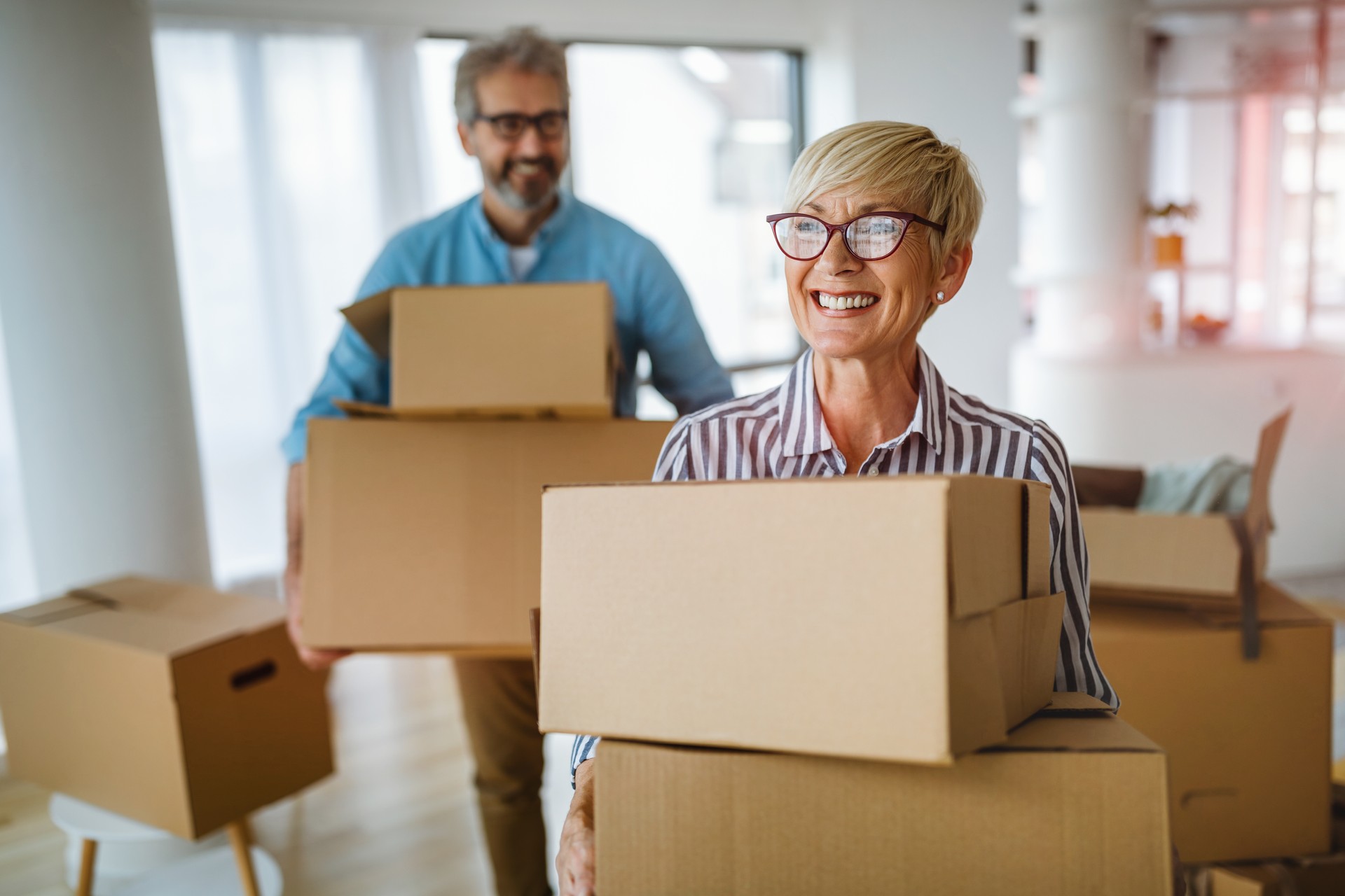 Portrait of happy senior couple in love moving in new home